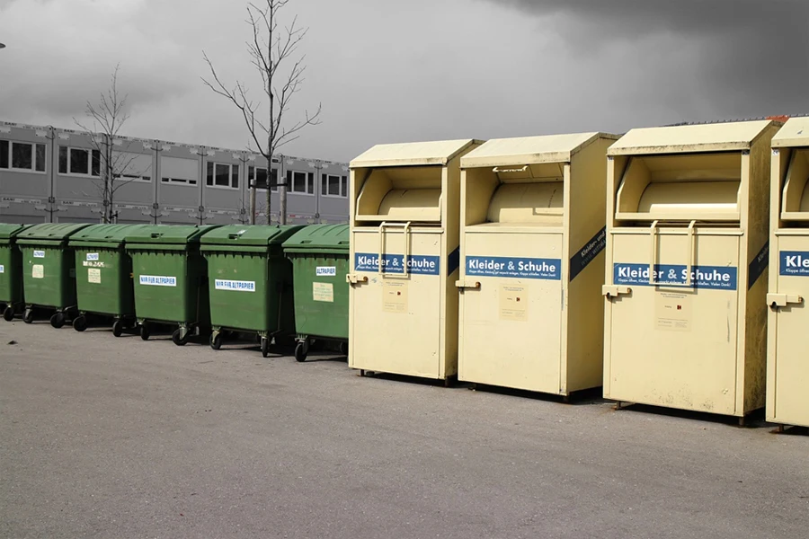 Several garbage cans lined up in a row