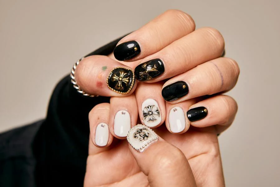 Short black and white nails with gold bling accents