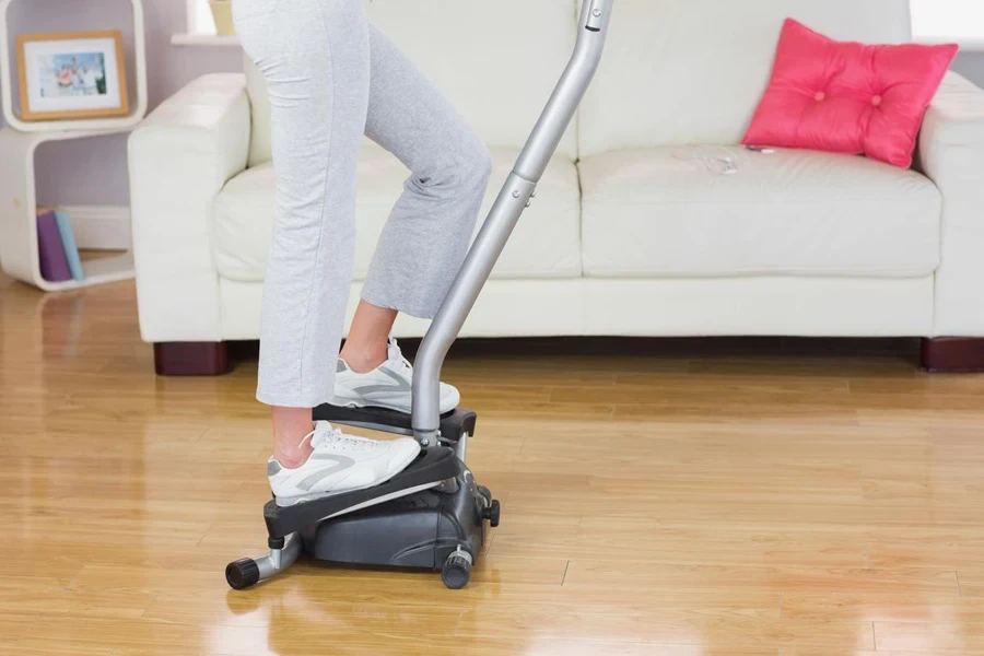 Sporty woman exercising on step machine