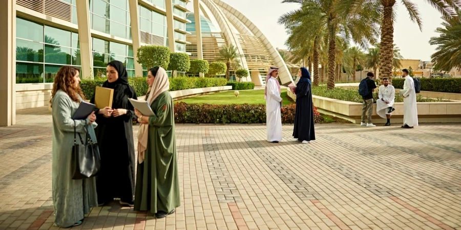 Teacher and students discussing on university campus