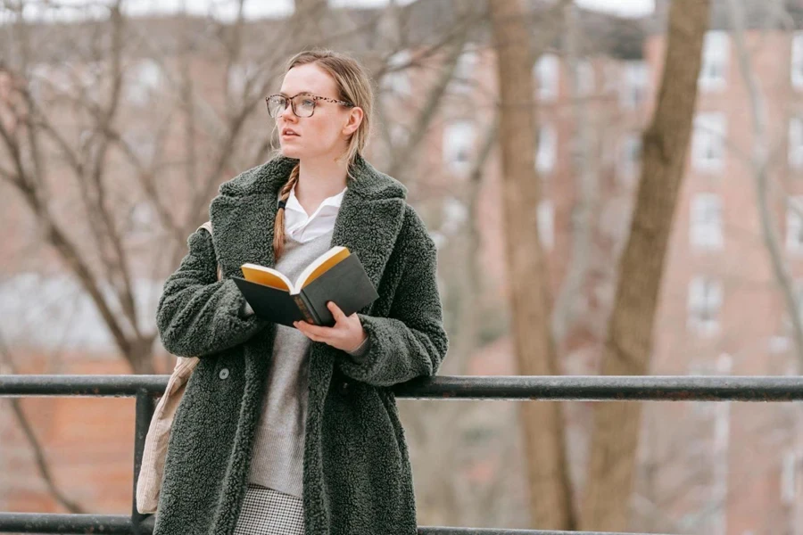 Thoughtful Woman with Book in Park