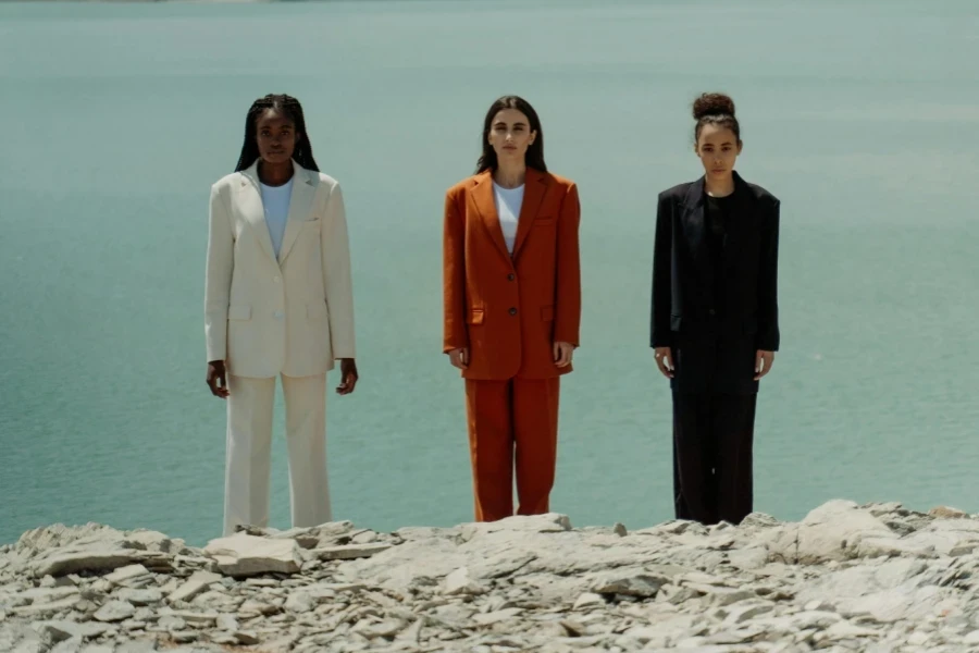 Three women in formal suits differing in style and color