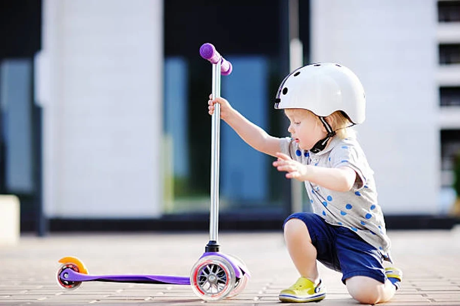 Toddler Boy Learning to Ride Scooter