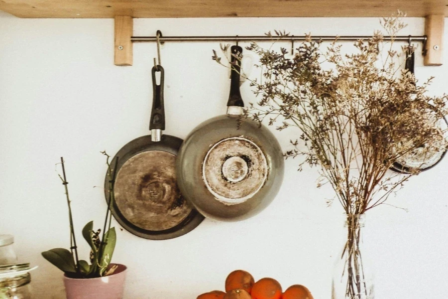 Two Gray Frying Pans Hanging on the Wall