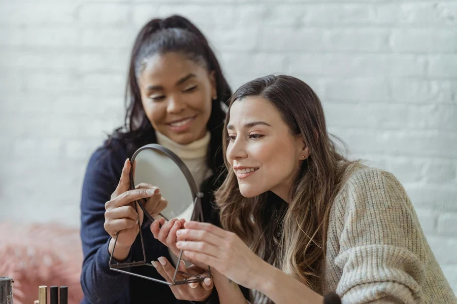 Two Women Using Makeup Mirror