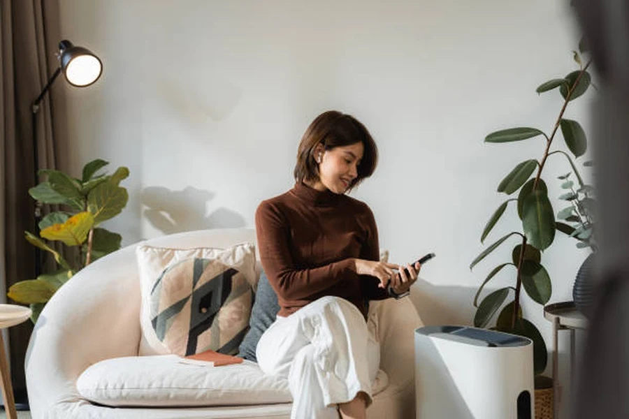 Woman Adjusting an Air Purifier Using Smart Home System on Her Phone