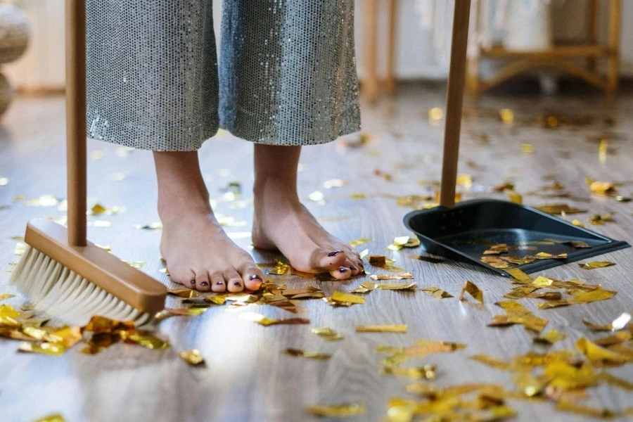 Woman Cleaning with Broom and Dustpan