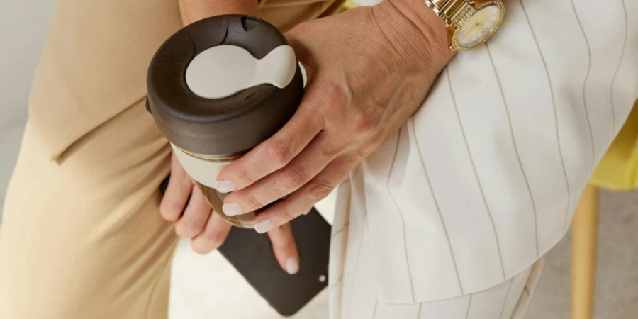 Woman Holding a Brown Tumbler