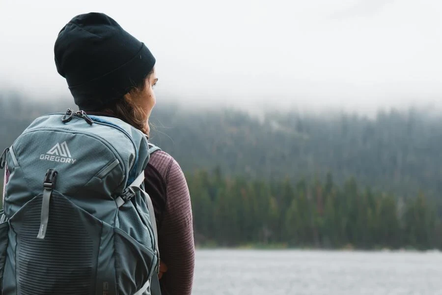 Woman carrying a backpack with zippers and safety straps