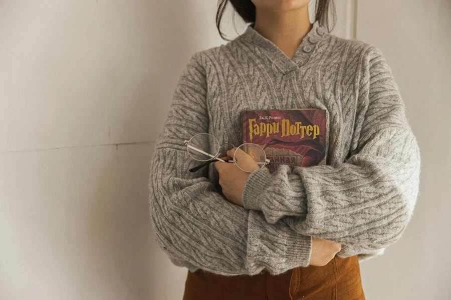 Woman in Gray Sweater Holding a Book