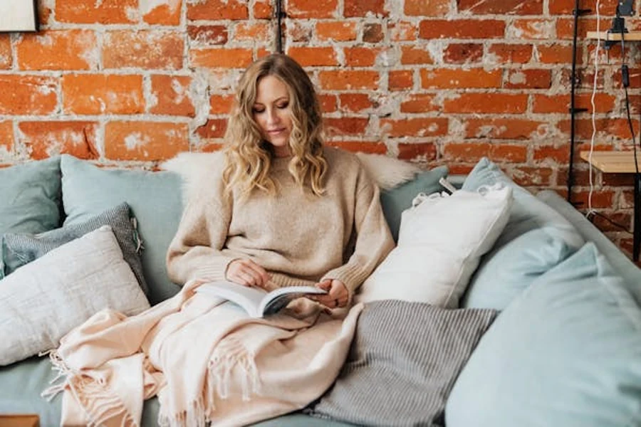 Woman in Sweater Reading a Book