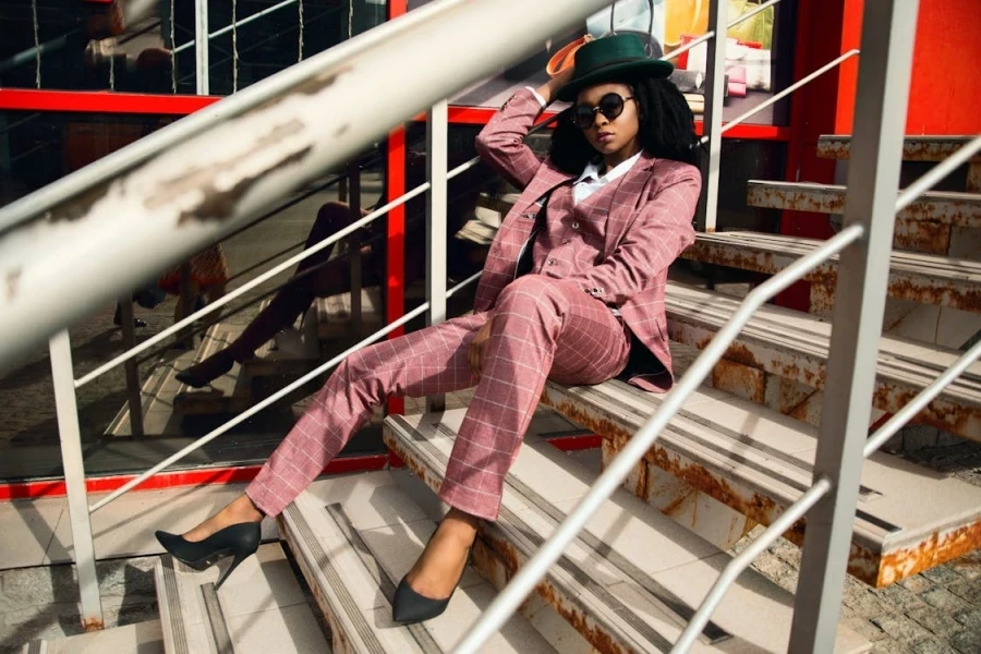 Woman in a formal, three-piece pink checked suit