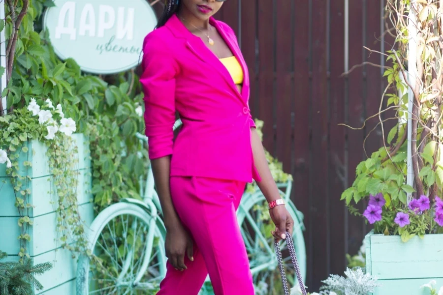 Woman in a snug fitting pink formal suit