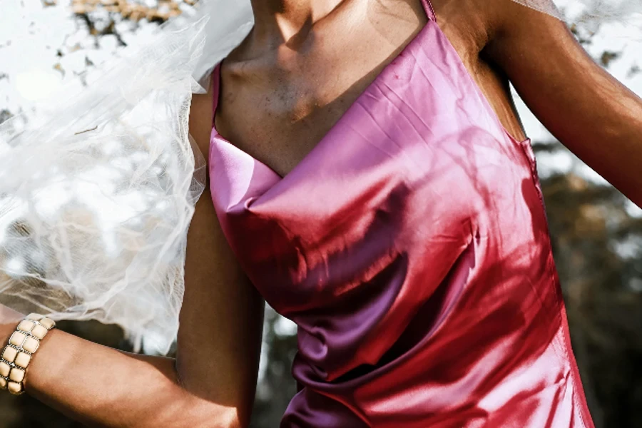 Woman in pink cowl neck silk dress