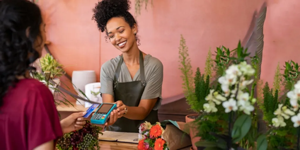 Woman paying for products using a contactless credit card