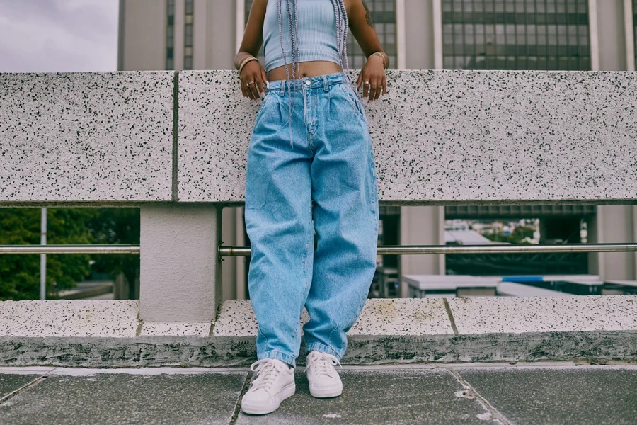 Woman rocking high-waisted baggy jeans and a crop top