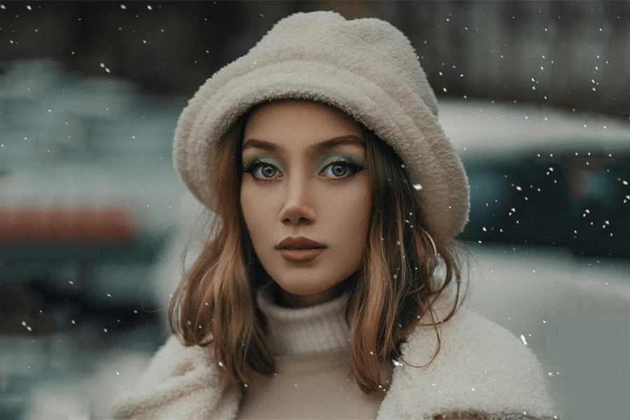 Woman wearing a fuzzy white winter bucket hat