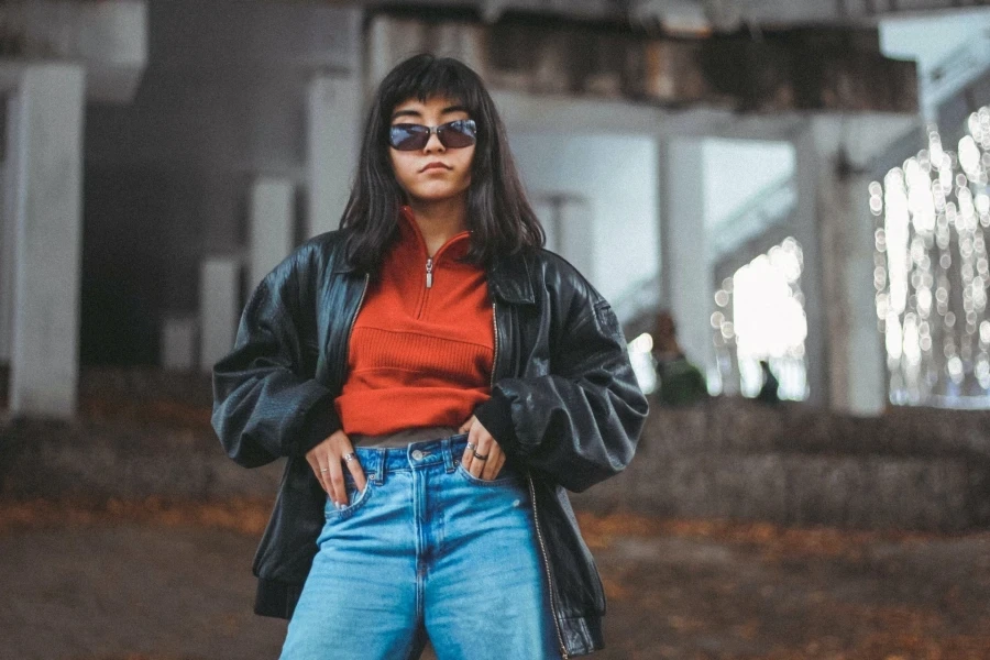 Woman wearing oversized black leather pilot jacket