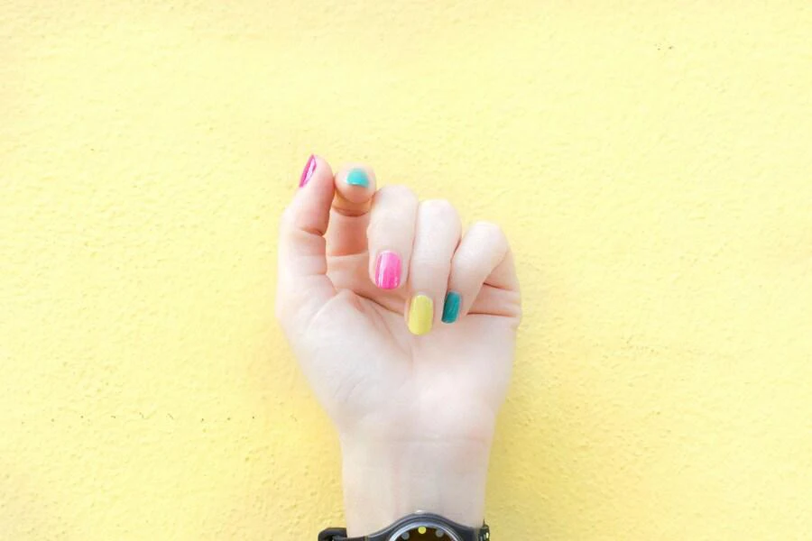 Woman’s fingers in different nail colors