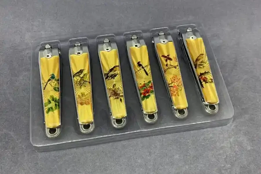 Yellow nail clippers lined up on a tray