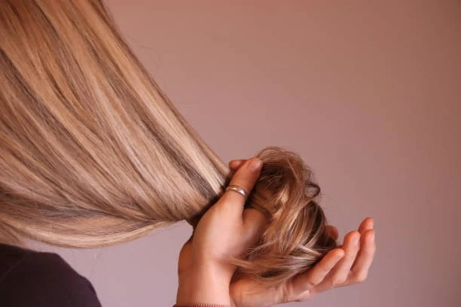 Young Woman Touching Her Blonde Perfect Hair