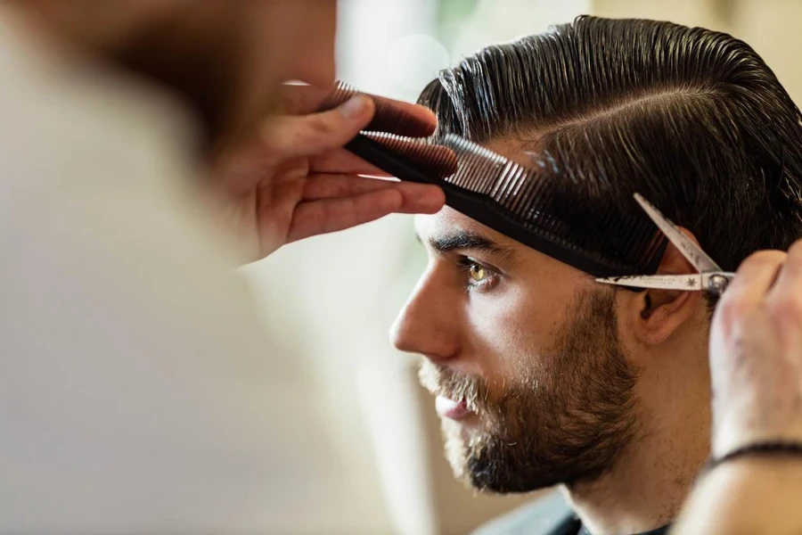 Young man getting his hair cut at a barber shop