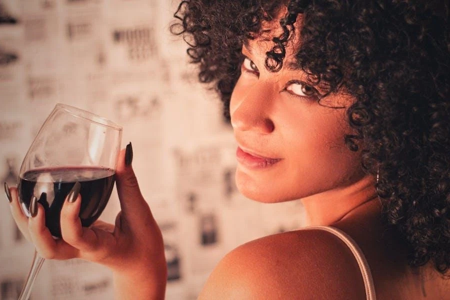 Young woman holding a red wine glass