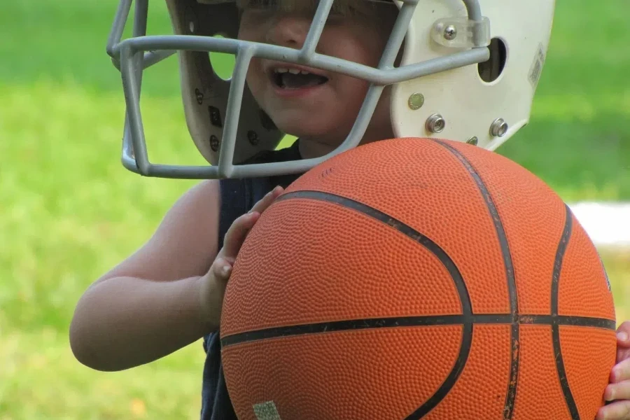 A 3-year-old boy playing with basketball