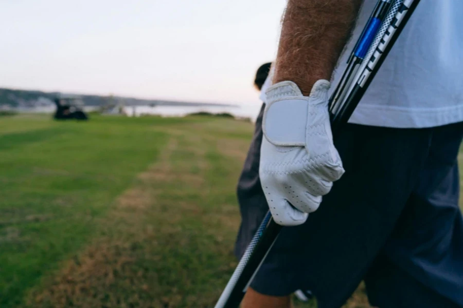 a Person Wearing White Golf Gloves