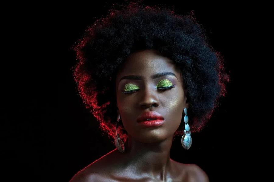 A dark-skinned woman with beautiful, inclusive makeup