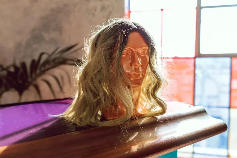 A gold mannequin with a blonde wig