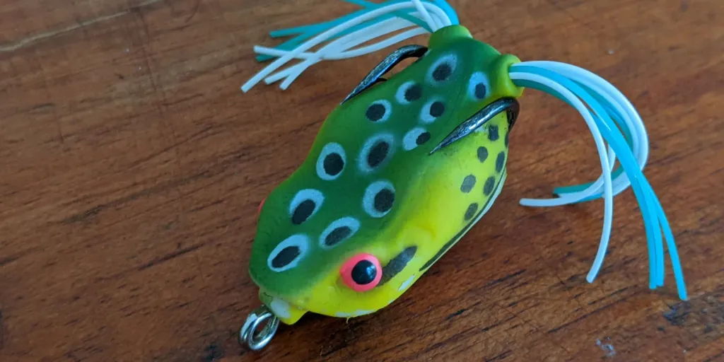 A green frog lure on a table