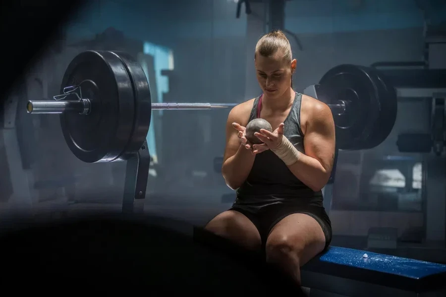 A shot put athlete holding shot put in gloves