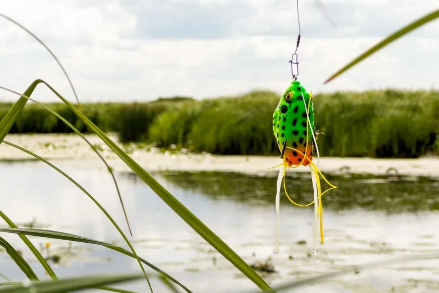 A silicone frog bait hanging on a fishing hook