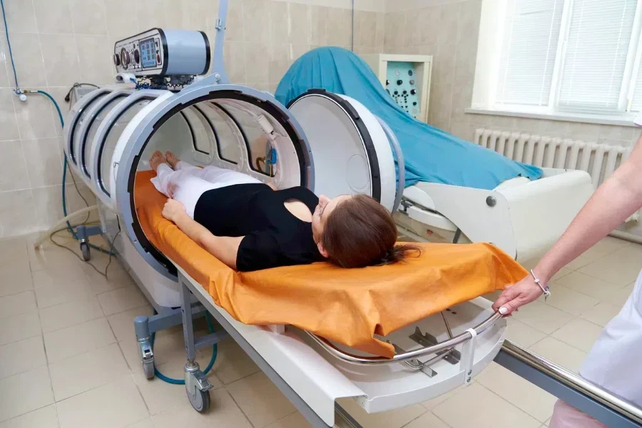 A woman inside a hyperbaric oxygen therapy chamber