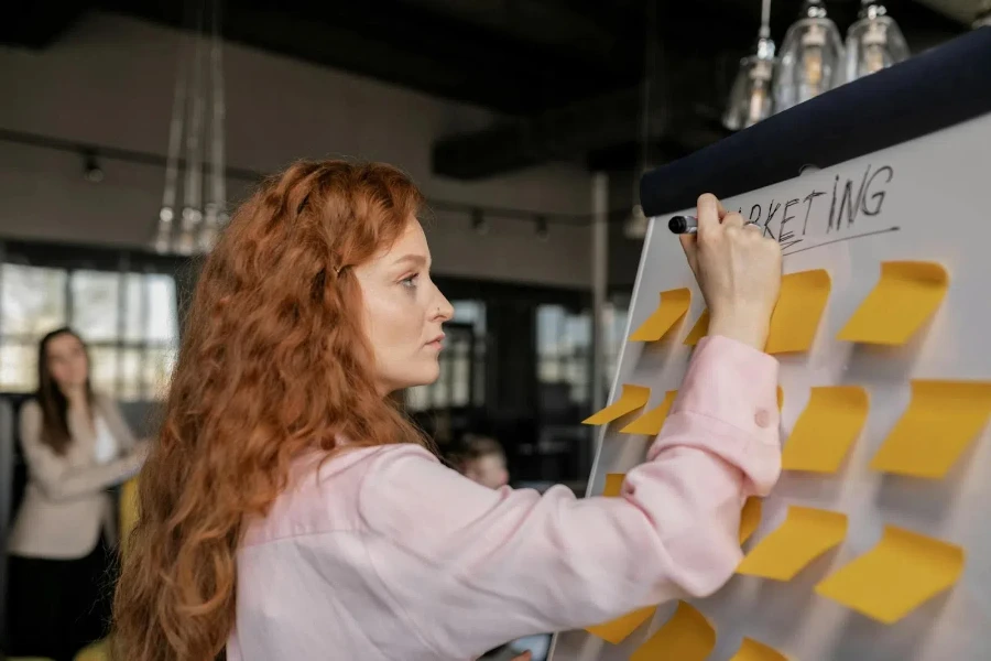 A woman writing group brainstorming ideas on sticky notes