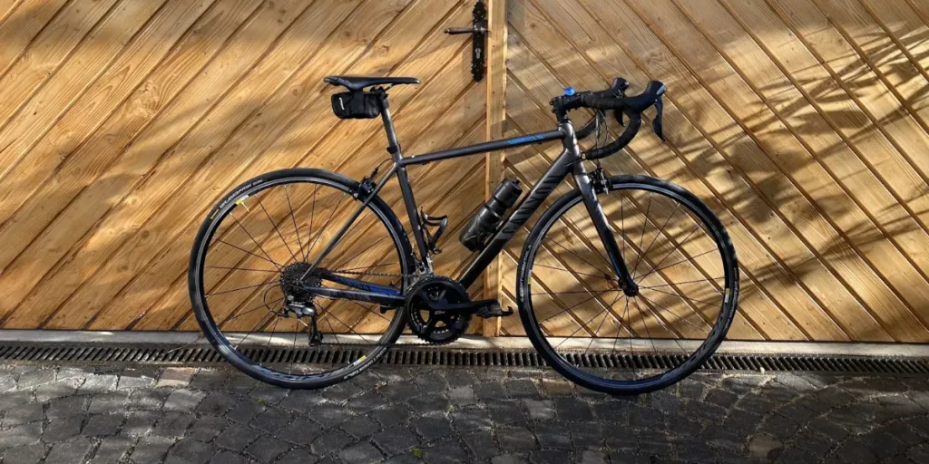 Black street bike leaning on door with great pride