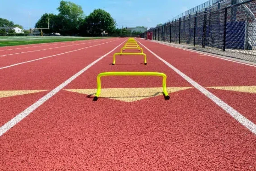 Bright yellow agility hurdles lined up on running track