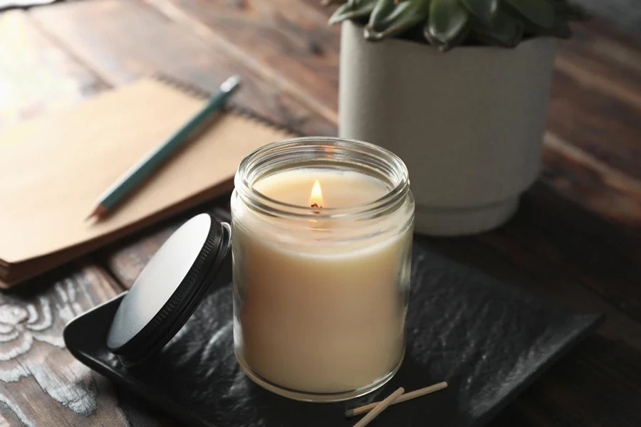 burning candle in glass jar