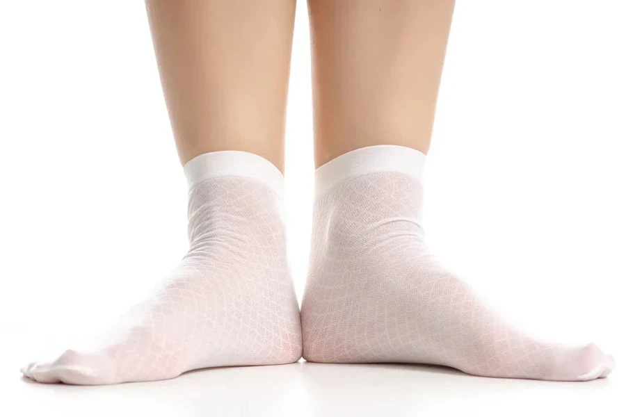 Female legs in white sheer socks