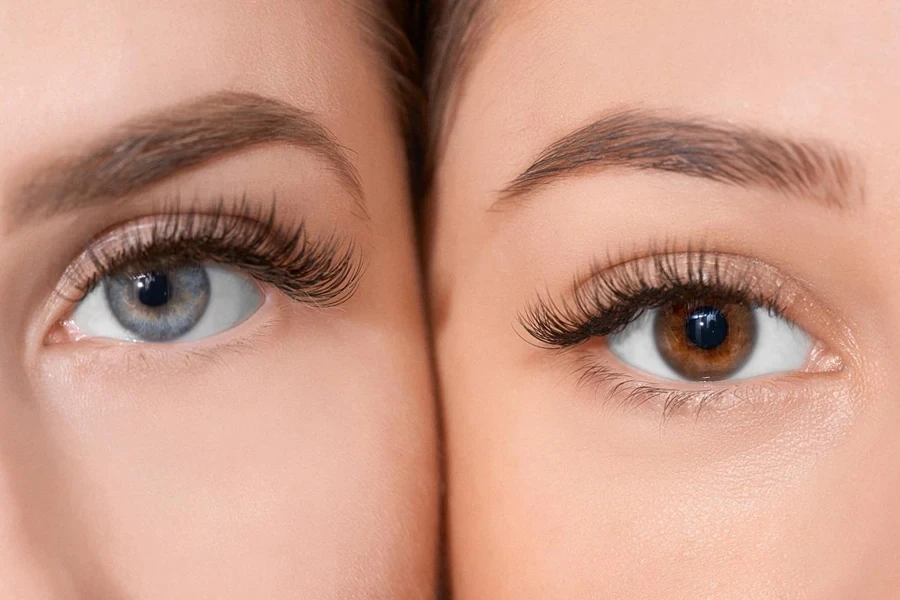 front view of human eyes looking at camera.blue and hazel colors.false eyelashes.