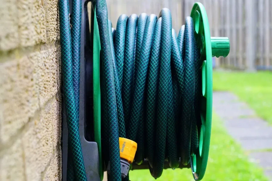 Green water hose attached to the wall