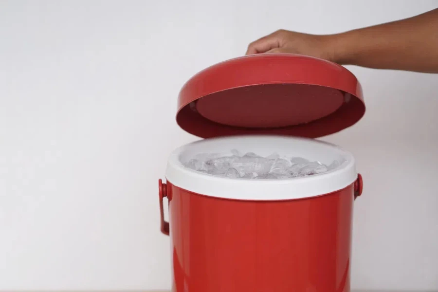 Hand going into ice bucket with red lid