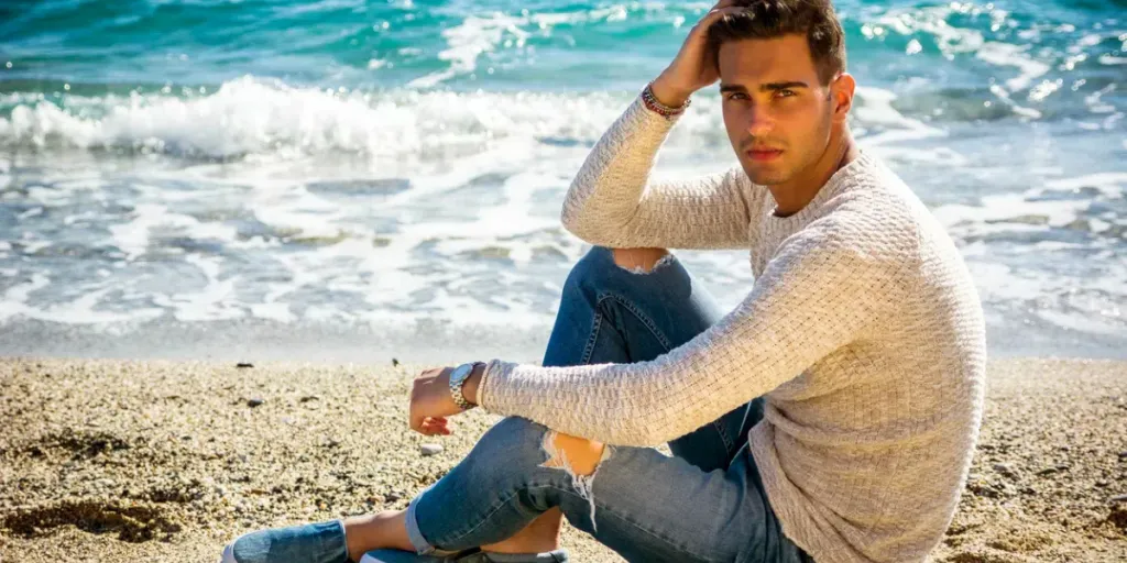 Handsome man in a crewneck and blue rugged jeans