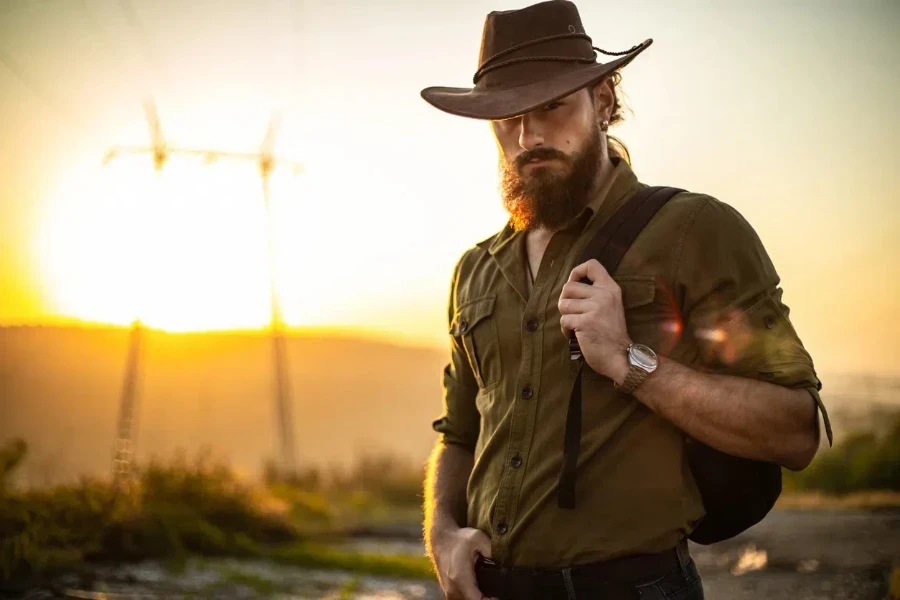 Handsome man in a Western button-up shirt and cowboy hat