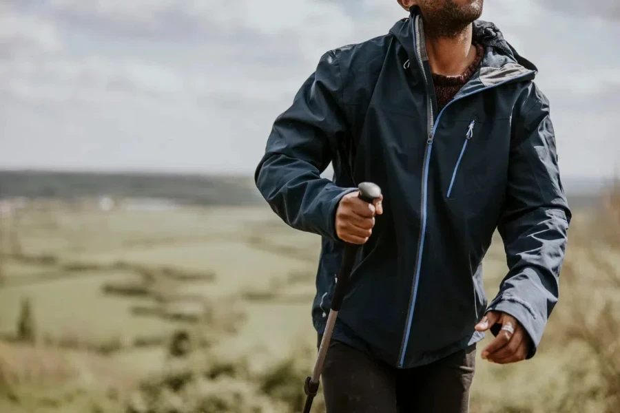 Man hiking in a black single-layer nylon windbreaker