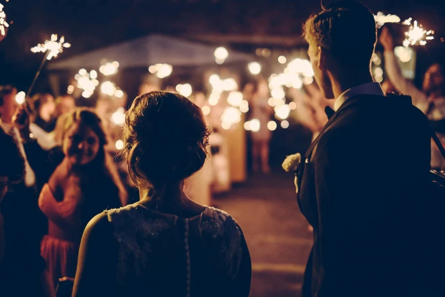 man standing near the woman walking at a party during nighttime