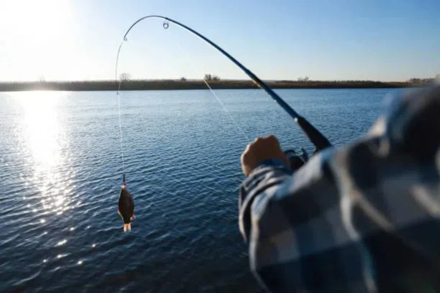 Man using a pinfish lure to attract fish in lake