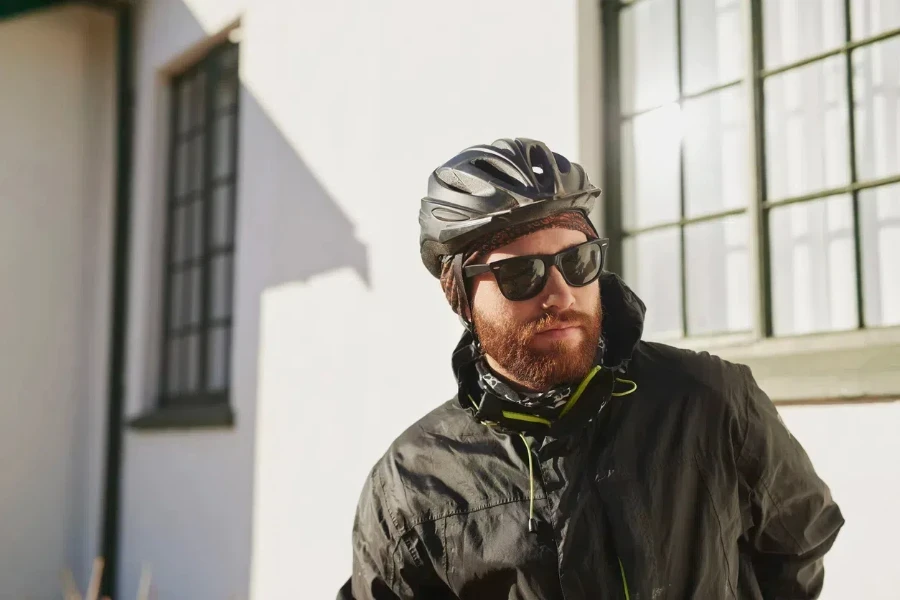 Man wearing a helmet in a black tricot windbreaker