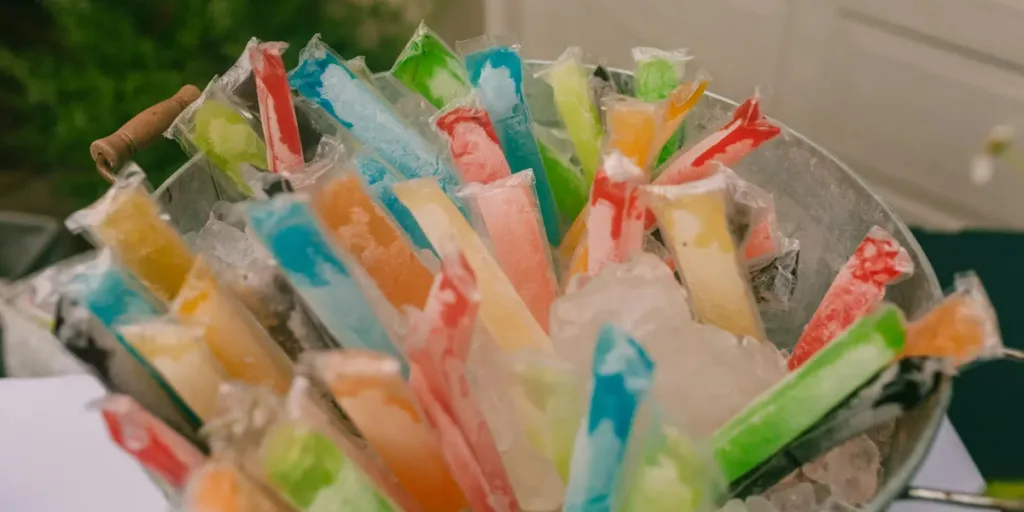 Metal outdoor ice bucket full of colorful frozen items